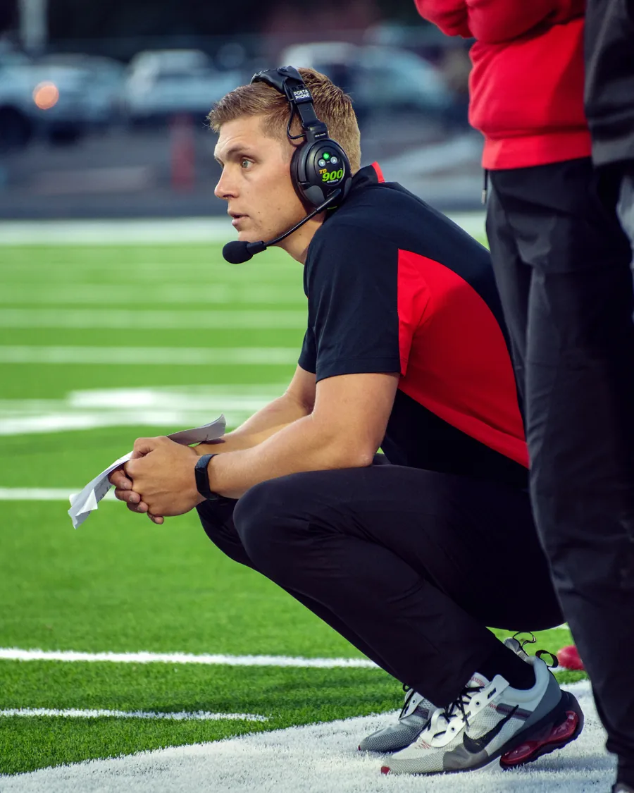 Coach with a headset directing from the sideline