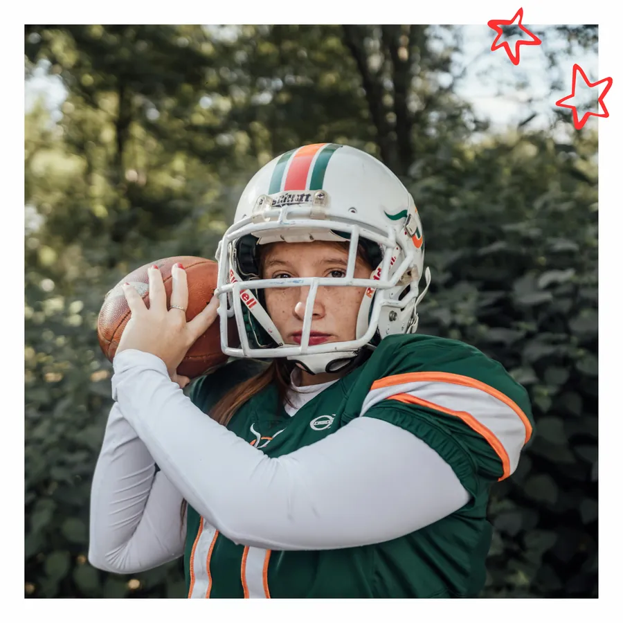 Female football player holding the ball